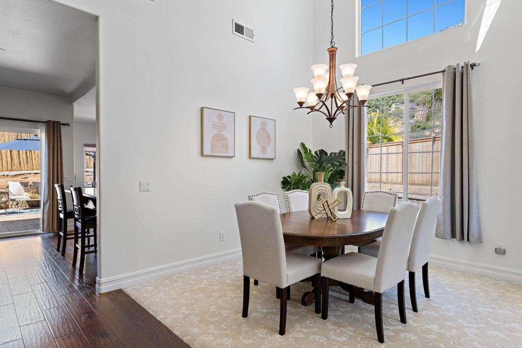 655 Dimaio Way Escondido, CA 92027 - Photo 8 of 46 a dining room with furniture potted plants and wooden floor