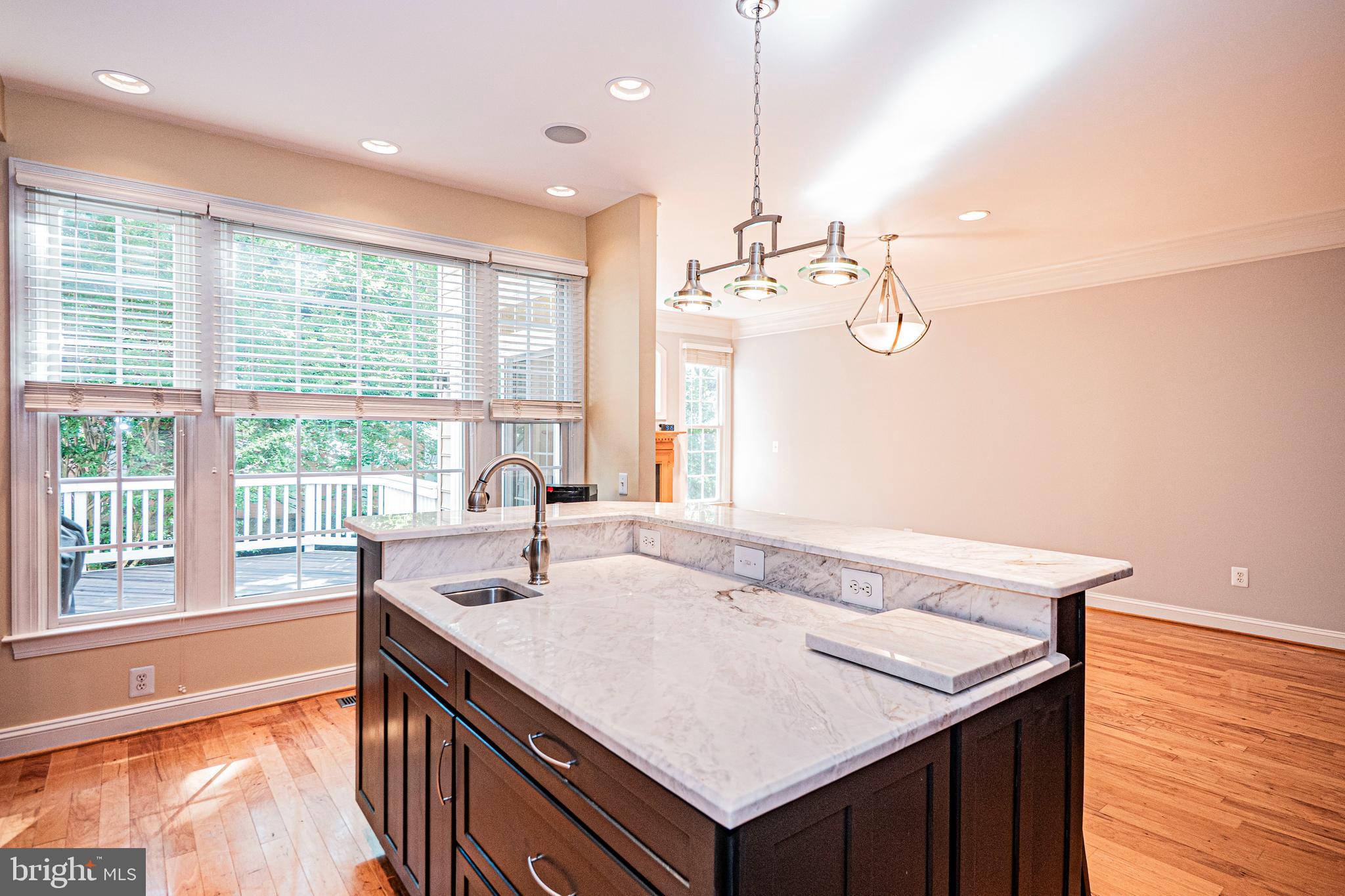 5448 Edsall Ridge Place Alexandria, VA 22312 - Photo 10 of 52 a kitchen with a sink a large window and wooden floor