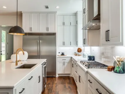 a kitchen with a sink stainless steel appliances and cabinets