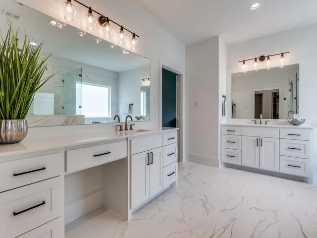 a bathroom with a double vanity sink mirror and bathtub