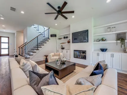 a living room with furniture a fireplace and a flat screen tv