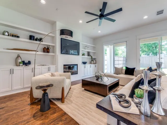 a living room with furniture fireplace and a table