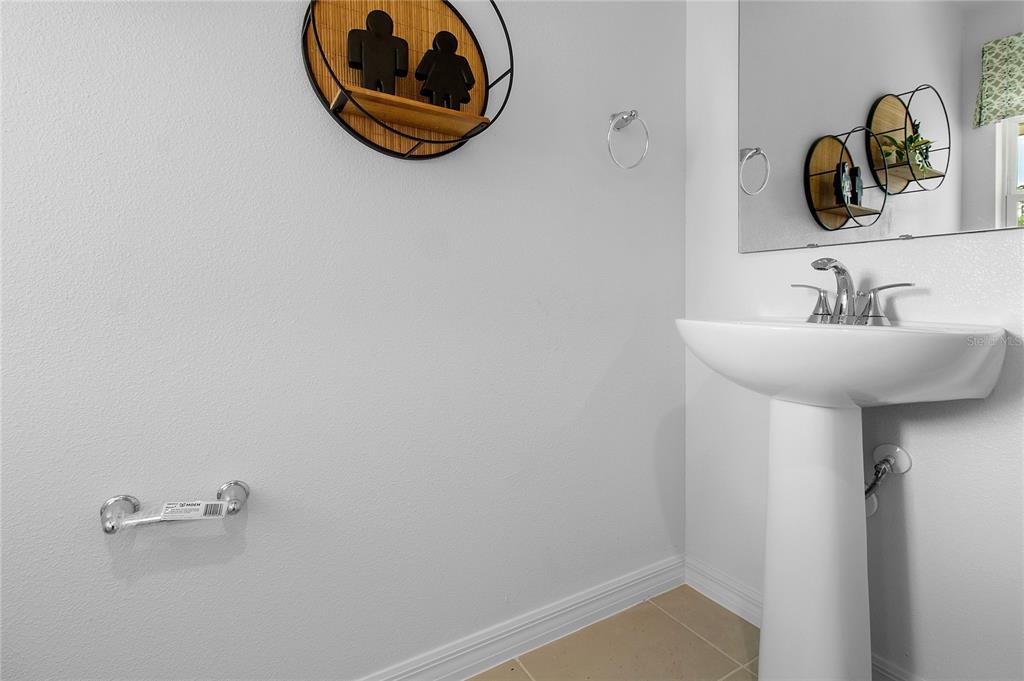 16639 Luminary Loop Clermont, FL 34714 - Photo 24 of 26 a bathroom with a sink and mirror