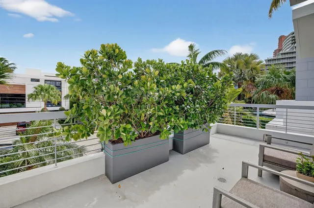a living room with furniture a flat screen tv and a large window