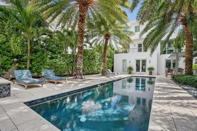 a dining hall with stainless steel appliances granite countertop a couch and chairs