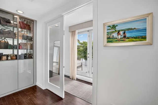 a front view of a house with a yard and potted plants