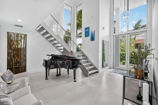 a living room with furniture and large windows