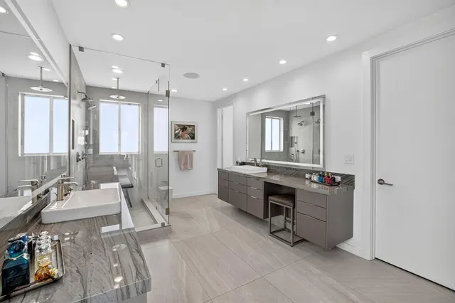 a view of a dining room and livingroom with furniture wooden floor a chandelier