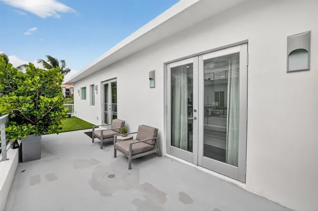 a view of a patio with table and chairs potted plants with large tree