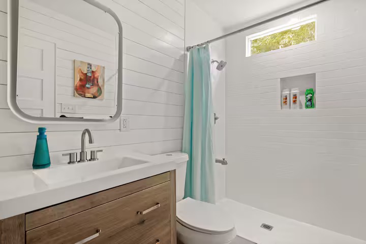 307 East 35th Street, Unit A Austin, TX 78705 - Photo 37 of 40 Bright white shiplap walls and a large vanity with a contemporary sink define this modern bathroom.