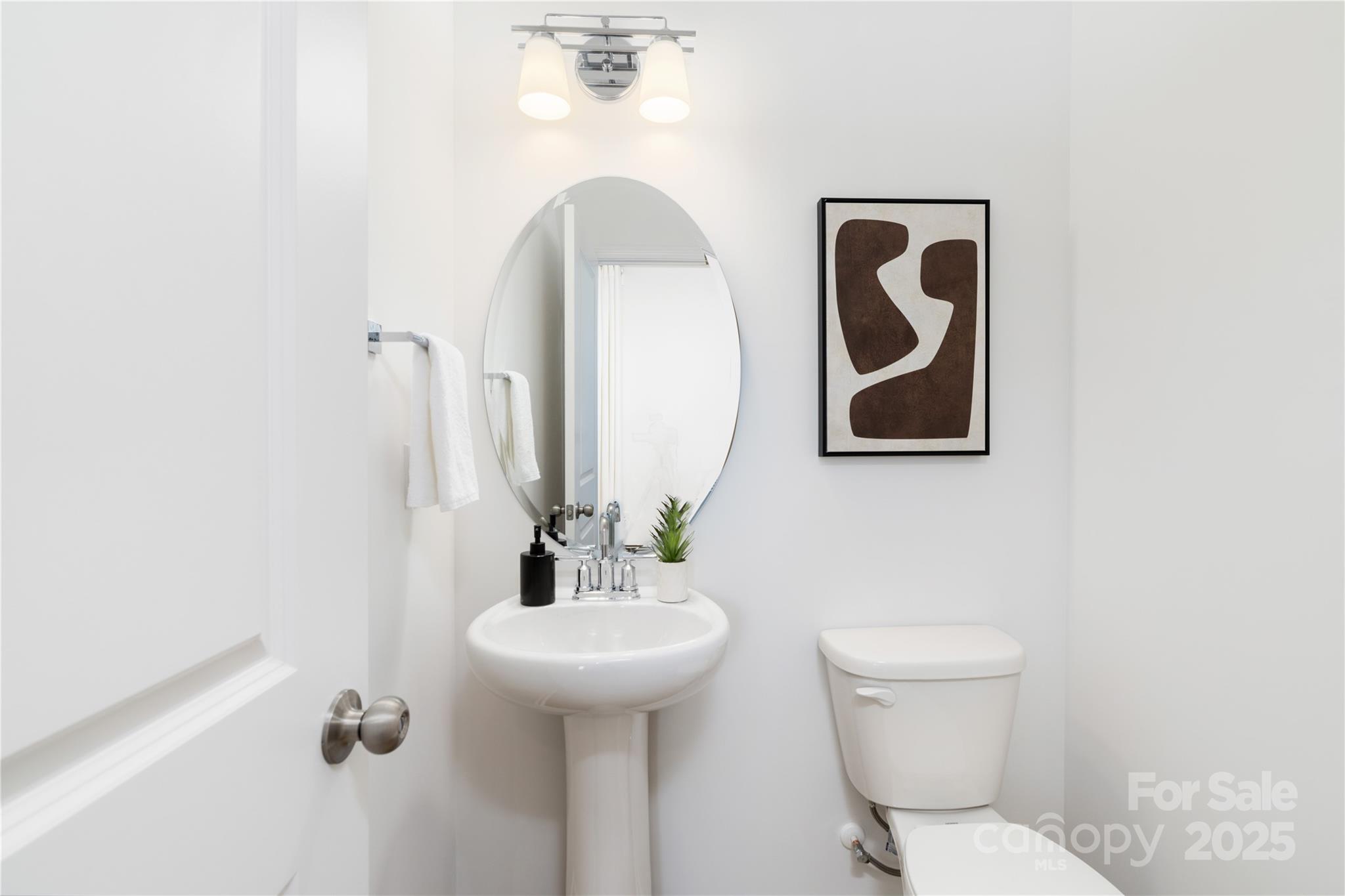 32562 B Millingport Road, Unit 7155 New London, NC 28127 - Photo 13 of 28 a bathroom with a toilet sink and mirror