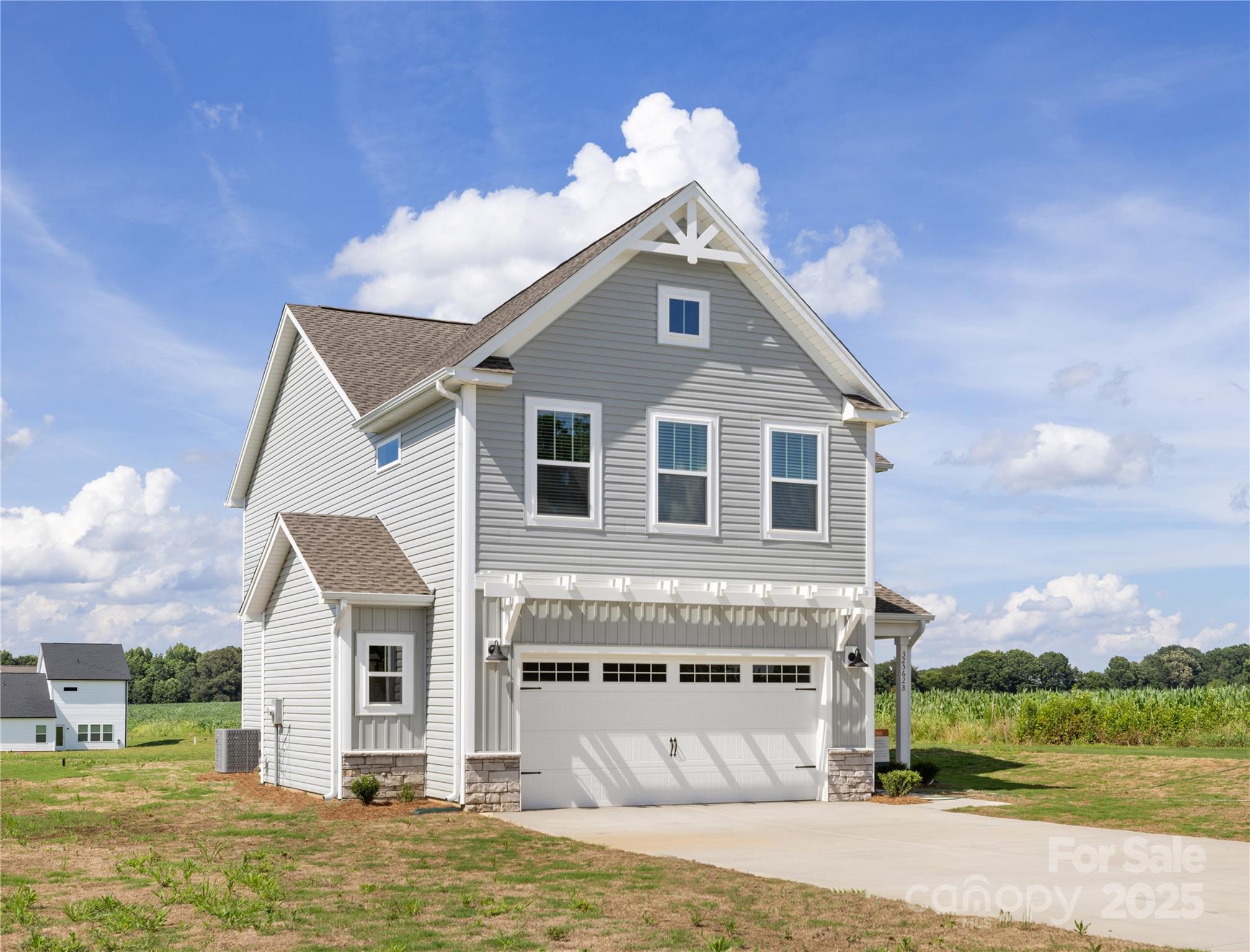 32562 B Millingport Road, Unit 7155 New London, NC 28127 - Photo 2 of 28 a front view of a house with a garden and plants