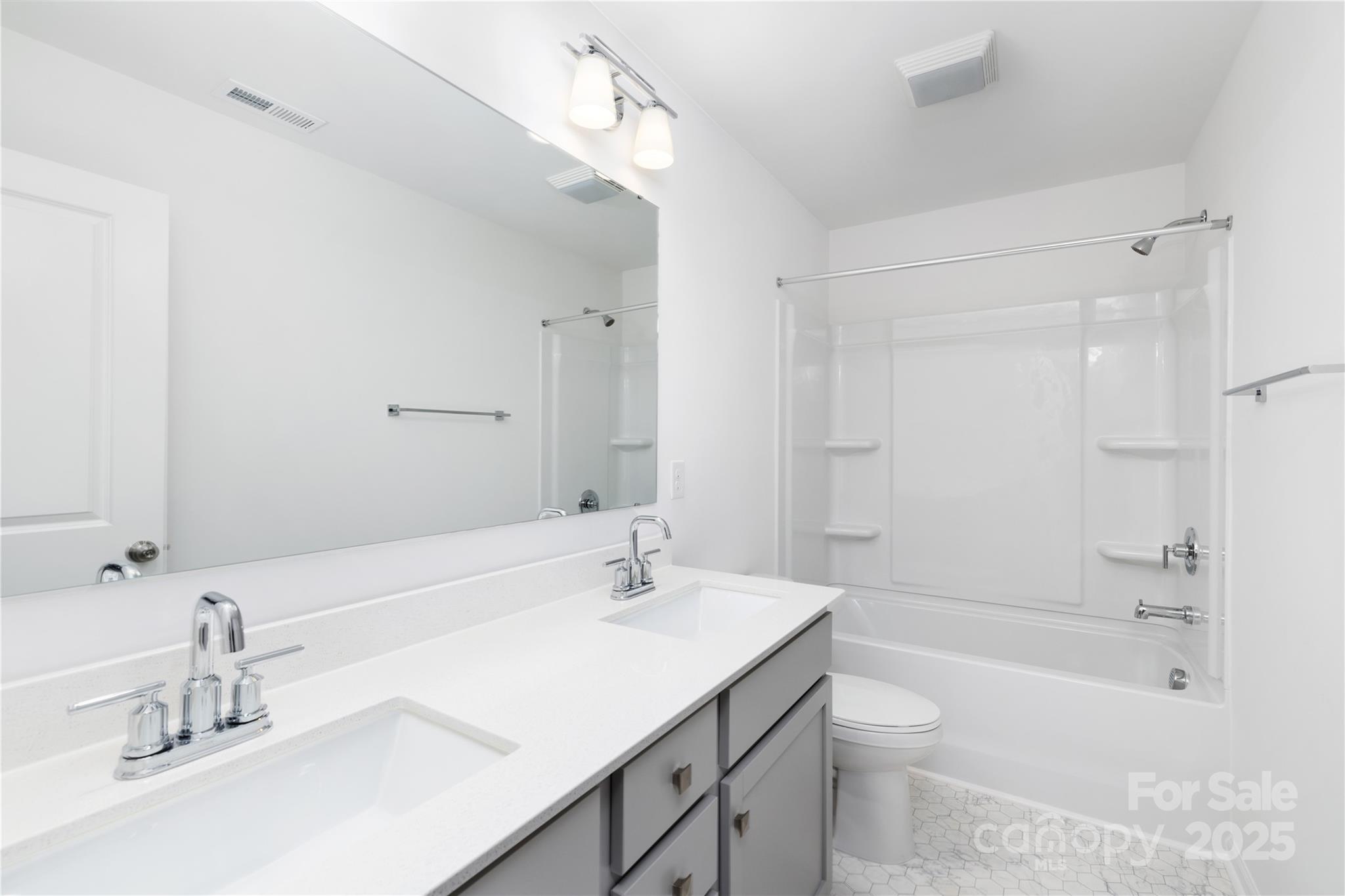 32562 B Millingport Road, Unit 7155 New London, NC 28127 - Photo 25 of 28 a bathroom with a sink a toilet a mirror and shower