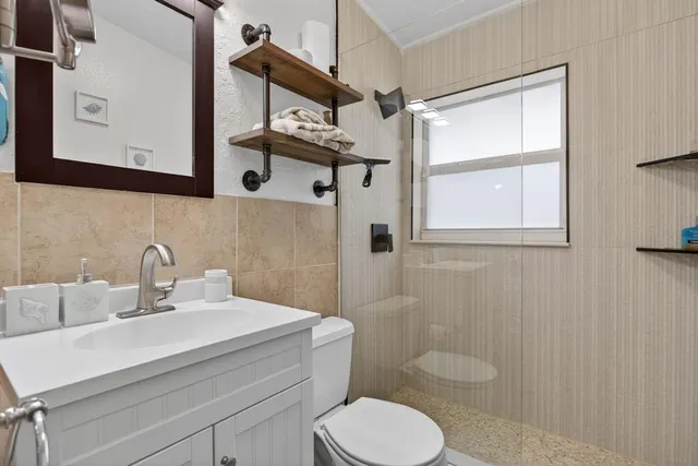 a bathroom with a sink a mirror and a toilet