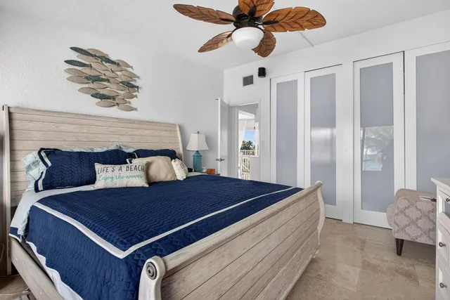 a bed sitting in a bedroom and table