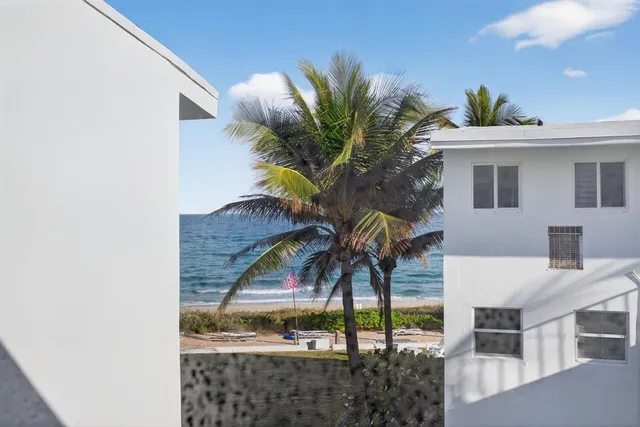 a view of a house with a palm tree