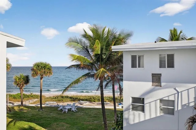 a view of a house with backyard porch and sitting area