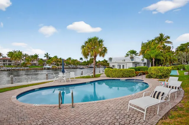 a view of a house with pool and chairs
