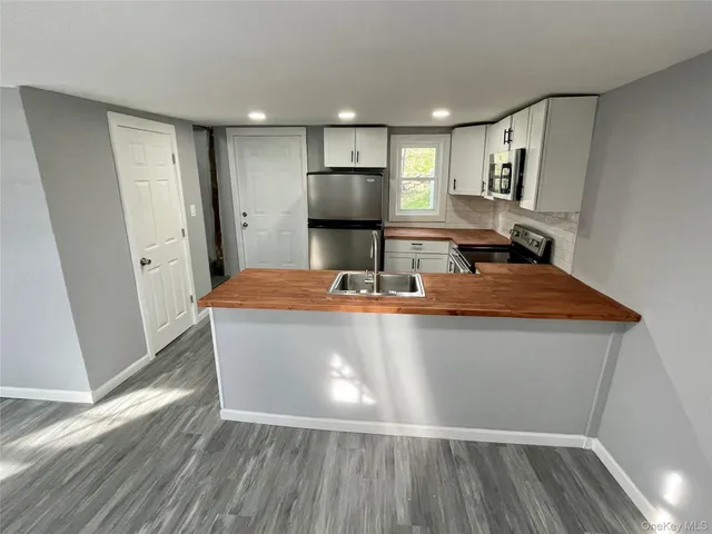 a room with wooden floor and cabinets