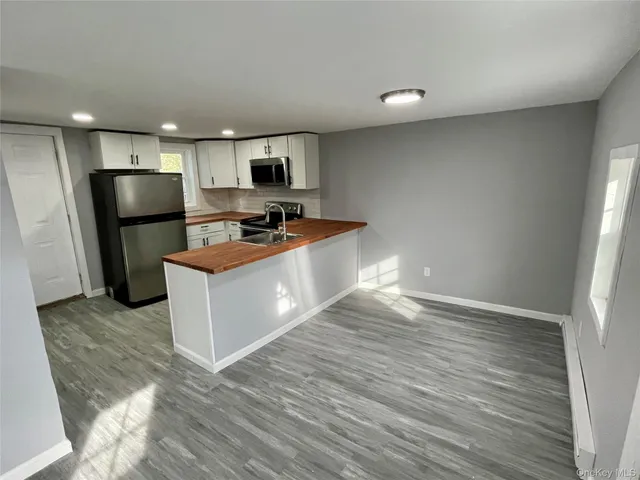 a kitchen with stainless steel appliances a refrigerator and a stove top oven