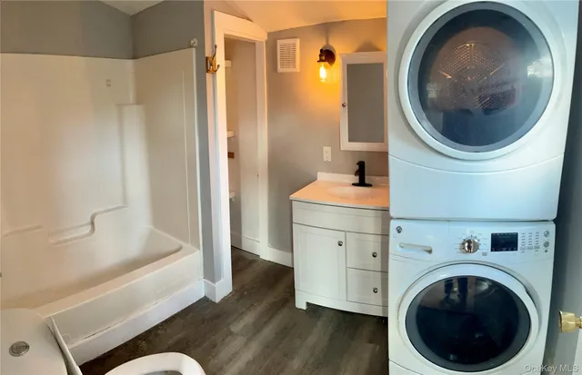 a bathroom with a sink a washer and dryer