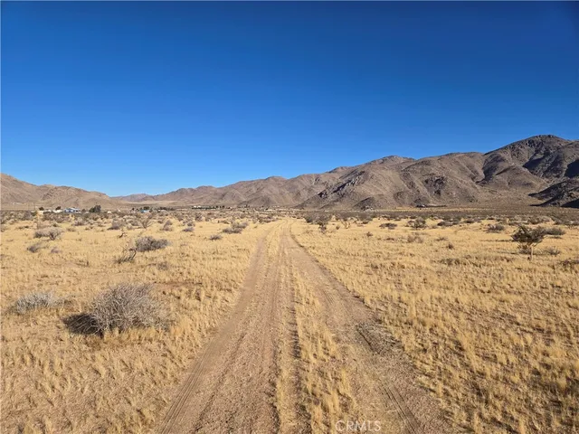 a view of mountain with a mountain in the background