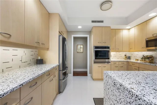 a large kitchen with granite countertop a sink and dishwasher stove top oven