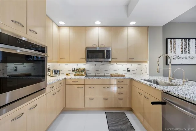 a kitchen with a sink stove and cabinets