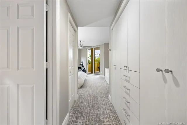 a view of a hallway with wooden floor and closet area