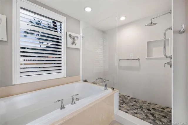 a bathroom with a bathtub and a shower
