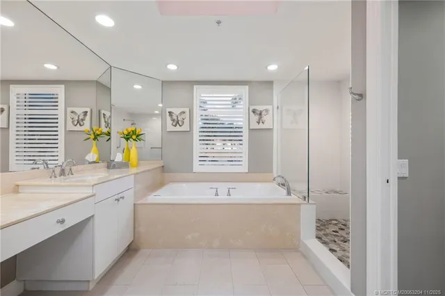 a bathroom with a tub a sink and a shower