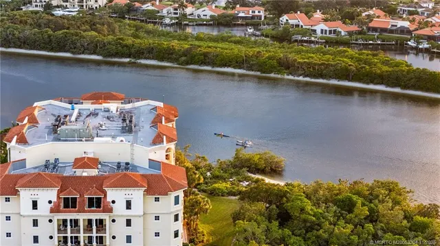 a bedroom with bed and large windows