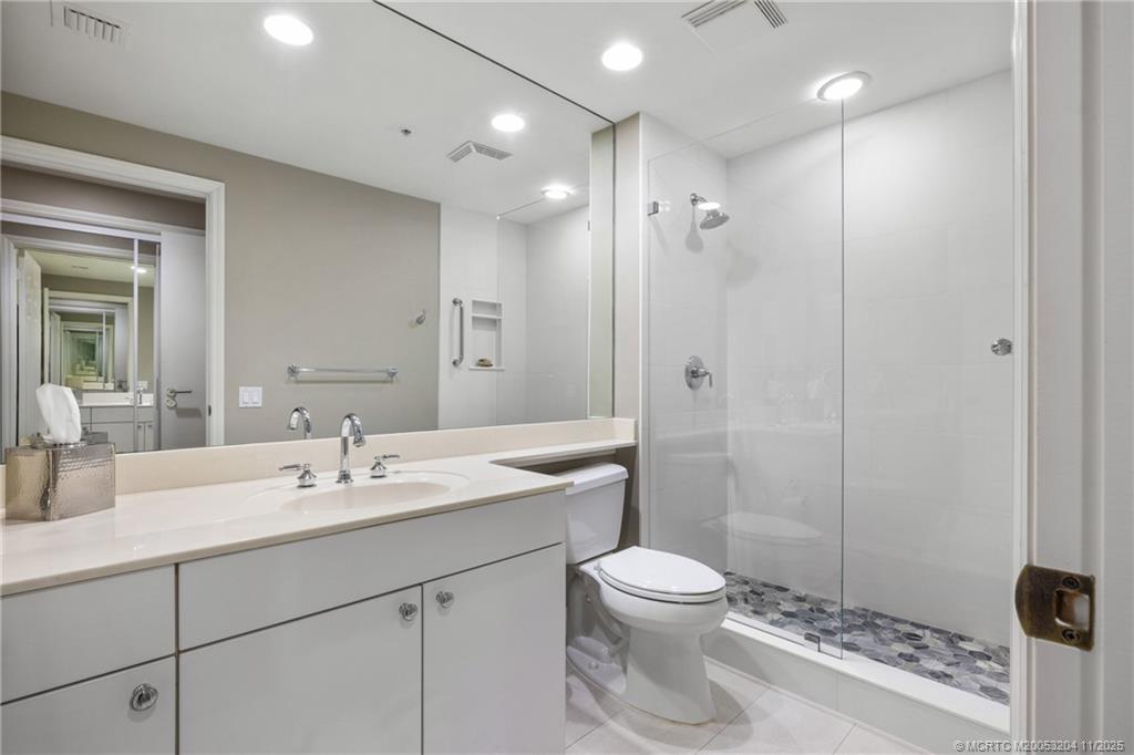 340 Highway 1, Unit 101 Jupiter, FL 33477 - Photo 29 of 42 a bathroom with a sink a toilet and shower