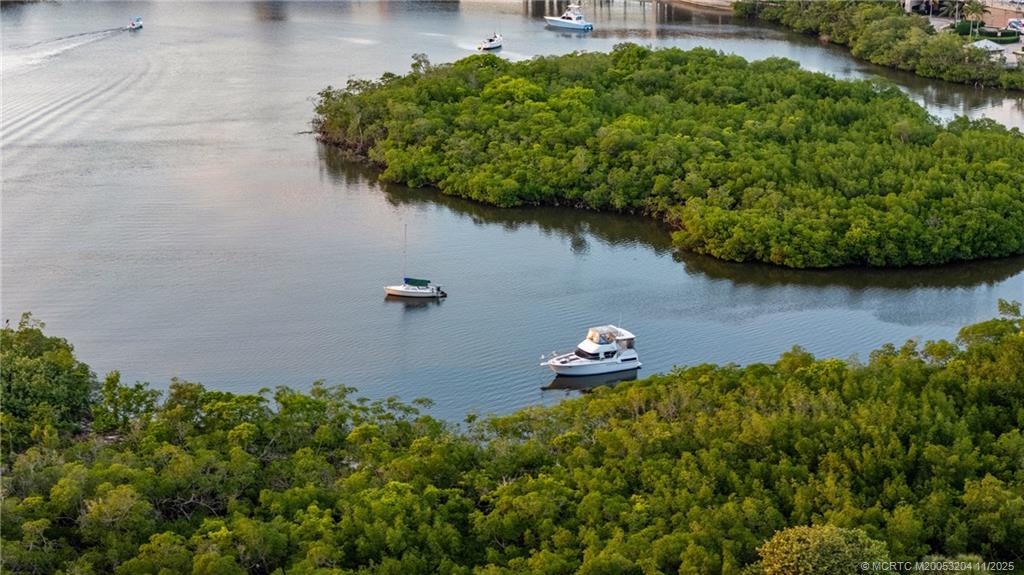 340 Highway 1, Unit 101 Jupiter, FL 33477 - Photo 41 of 42 an aerial view of a house with a yard and lake view