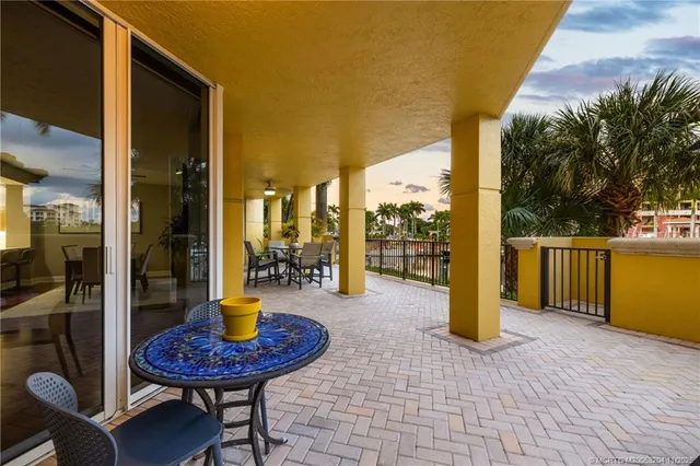 a view of a porch with chairs and backyard