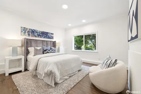 a bedroom with a large bed and a couch