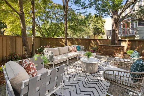 a view of a patio with couches chairs and a potted plant