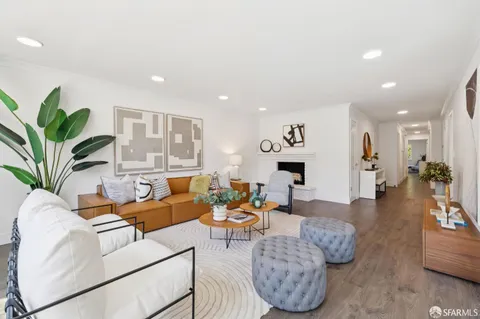 a living room with furniture potted plant and a fireplace