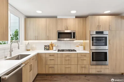a kitchen with a sink stove and microwave