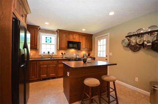 234 8 Lots Road Sutton, MA 01590 - Photo 3 of 30 a kitchen with granite countertop sink table and chairs