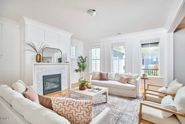 a living room with furniture windows and a fireplace