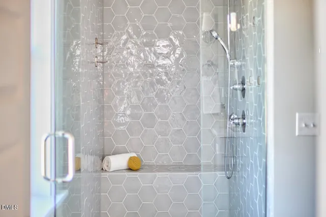 a bathroom with a granite countertop sink a large mirror and a shower