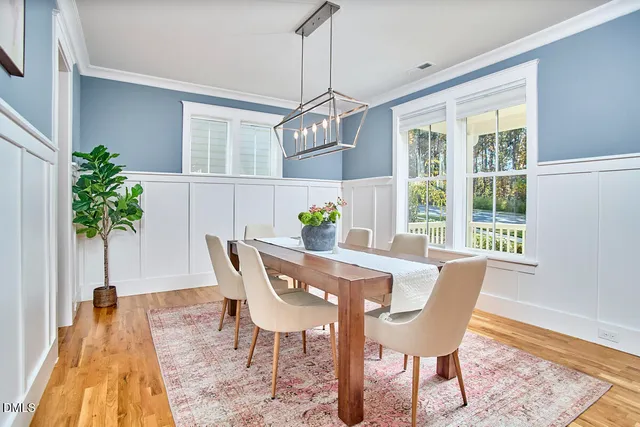 a dining room with furniture and a potted plant