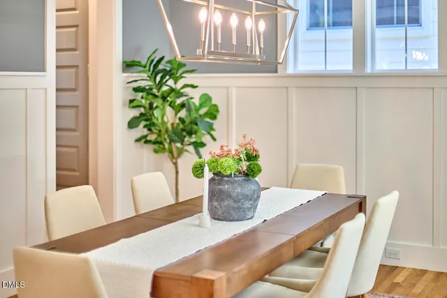 a living room with furniture fireplace and a large window