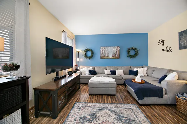 a living room with furniture and a flat screen tv