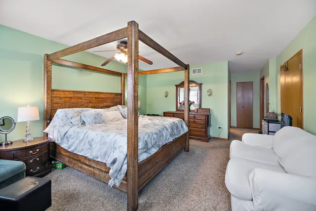 a bedroom with a bed and a mirror