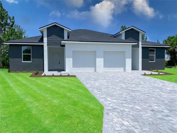 a front view of a house with a yard and garage