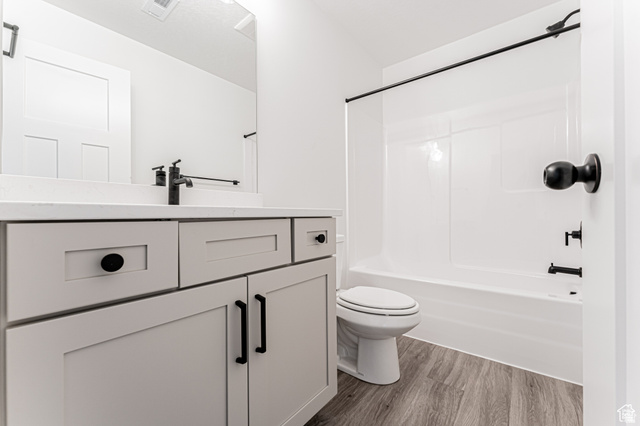 4774 Alder Drive Mapleton, UT 84664 - Photo 17 of 27 Bathroom with vanity, dark wood-style floors, and bathtub / shower combination