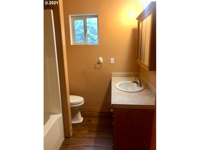311 Panda Road Washougal, WA 98671 - Photo 17 of 21 a bathroom with a granite countertop toilet and a sink