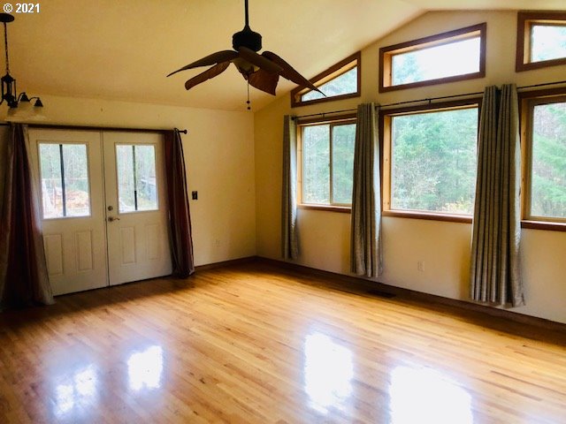 311 Panda Road Washougal, WA 98671 - Photo 8 of 21 an empty room with wooden floor and windows